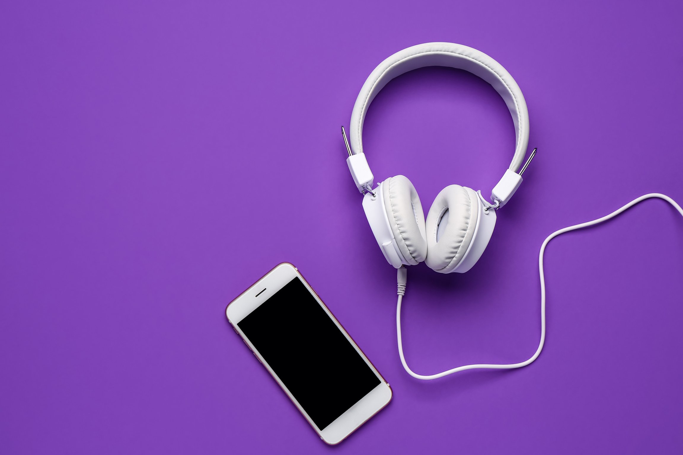 Mobile Phone with Headphones on Purple Background